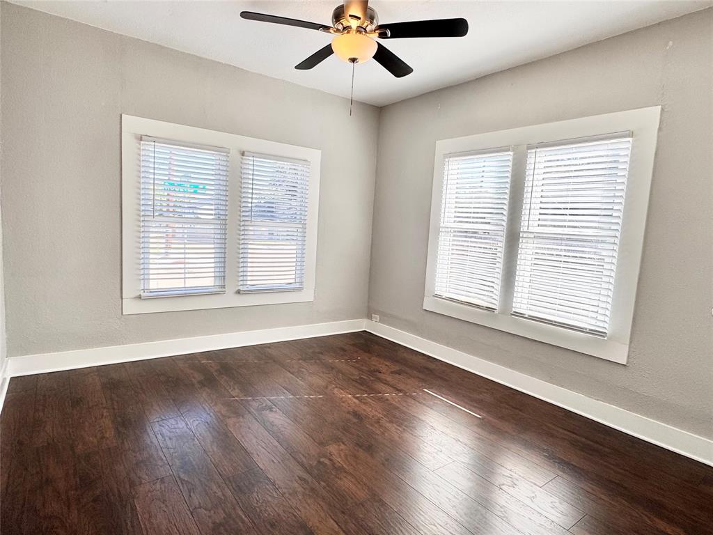 3455 Roberts Avenue Dallas, TX 75215 - Photo 13 of 25 a view of an empty room with wooden floor and a window