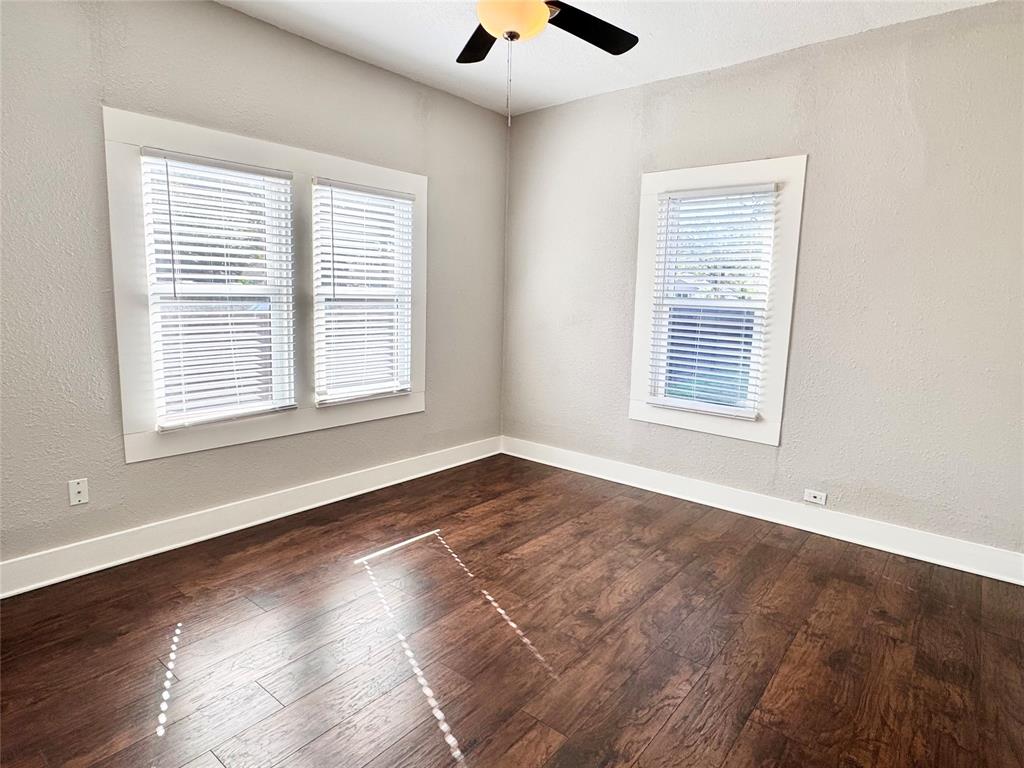 3455 Roberts Avenue Dallas, TX 75215 - Photo 18 of 25 a view of an empty room with wooden floor and a window