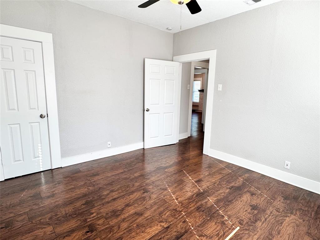3455 Roberts Avenue Dallas, TX 75215 - Photo 20 of 25 an empty room with wooden floor and windows