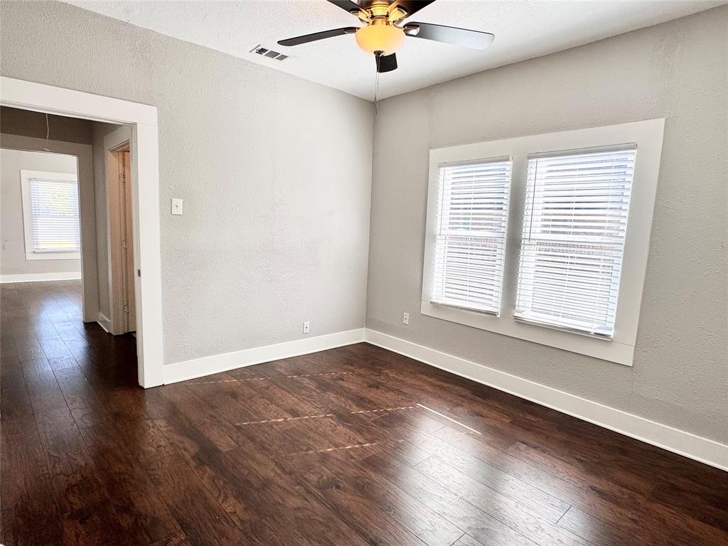 3455 Roberts Avenue Dallas, TX 75215 - Photo 21 of 25 a view of an empty room with wooden floor and a window