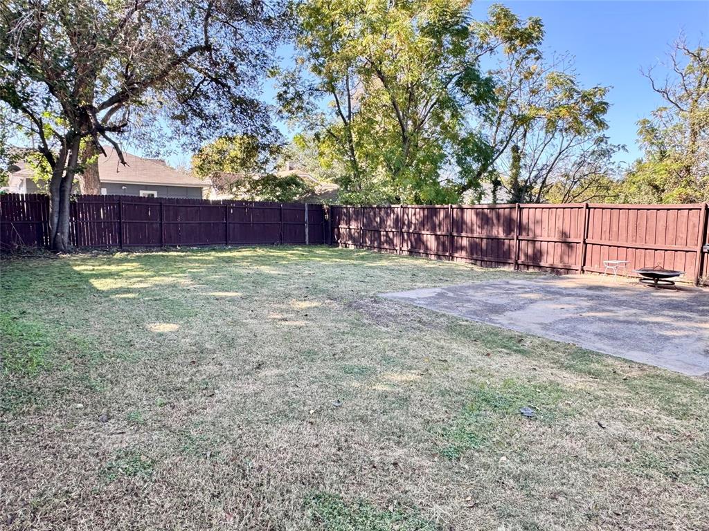 3455 Roberts Avenue Dallas, TX 75215 - Photo 23 of 25 a view of a yard with wooden fence and trees