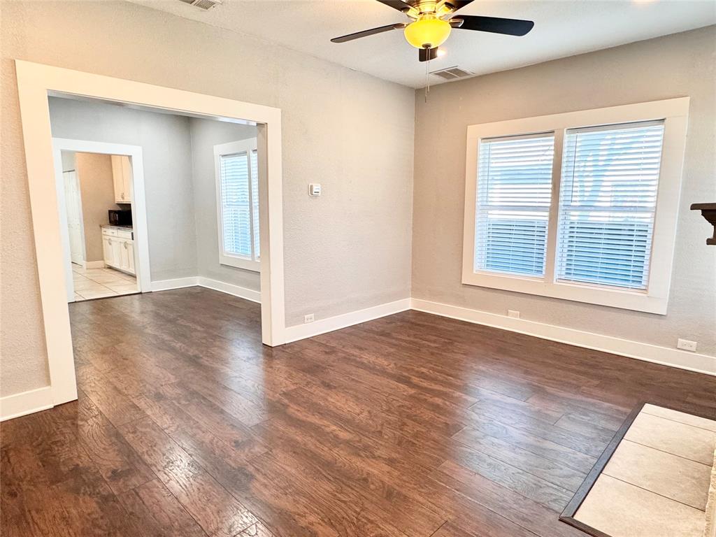 3455 Roberts Avenue Dallas, TX 75215 - Photo 7 of 25 a view of an empty room with window and wooden floor