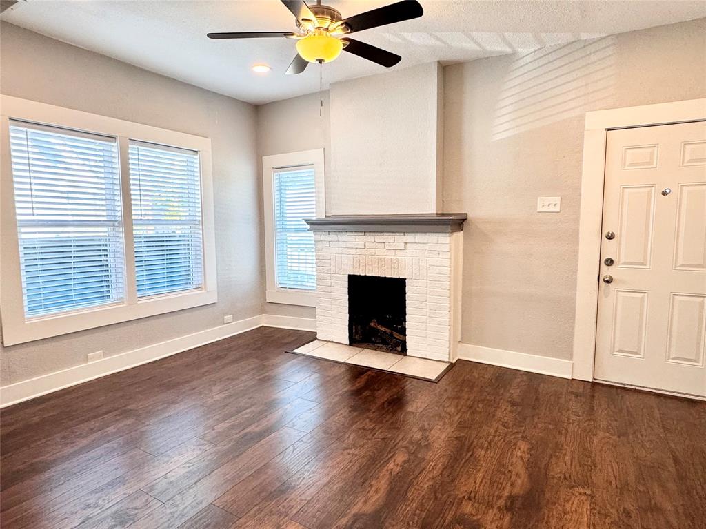 3455 Roberts Avenue Dallas, TX 75215 - Photo 8 of 25 a view of a livingroom with wooden floor a ceiling fan and windows