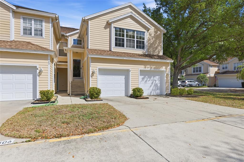 a front view of a house with a yard and garage