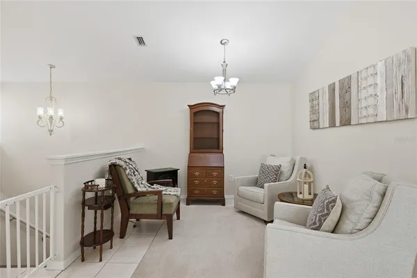 a living room with furniture and a chandelier