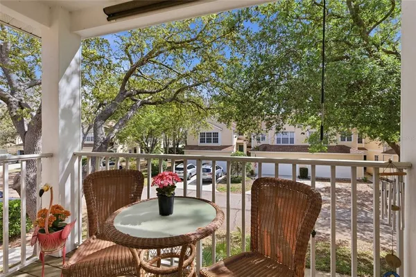 a balcony with table and chairs