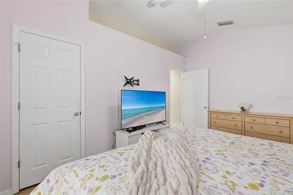 a bedroom with a bed and a flat screen tv