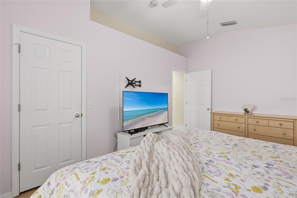 6406 Rosefinch Court, Unit 204 Lakewood Ranch, FL 34202 - Photo 16 of 36 a bedroom with a bed and a flat screen tv
