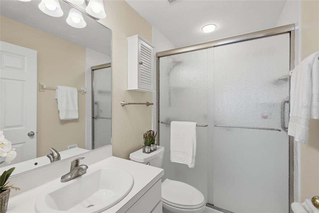 6406 Rosefinch Court, Unit 204 Lakewood Ranch, FL 34202 - Photo 17 of 36 a bathroom with a sink toilet and shower