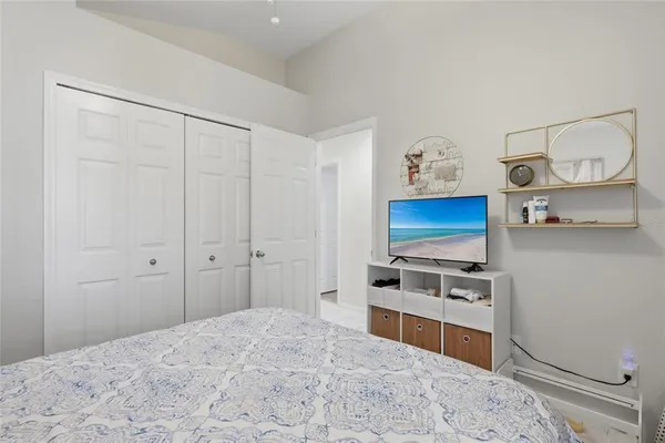 a bedroom with a bed and a television in it
