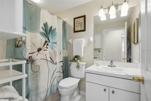 a bathroom with a sink and mirror with toilet