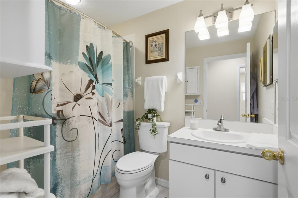 6406 Rosefinch Court, Unit 204 Lakewood Ranch, FL 34202 - Photo 20 of 36 a bathroom with a sink and mirror with toilet