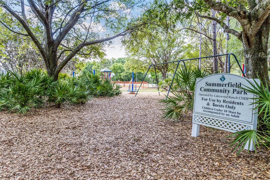 6406 Rosefinch Court, Unit 204 Lakewood Ranch, FL 34202 - Photo 25 of 36 a view of a bench in the garden