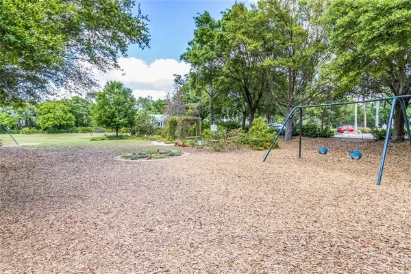 a view of backyard with green space and trees