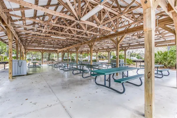 a view of a swimming pool with a table and chairs in patio