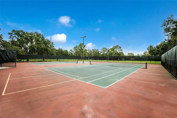 a view of an outdoor space and tennis court