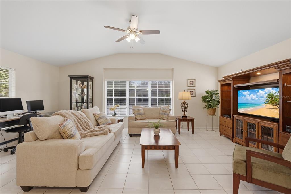 6406 Rosefinch Court, Unit 204 Lakewood Ranch, FL 34202 - Photo 5 of 36 a living room with furniture and a flat screen tv