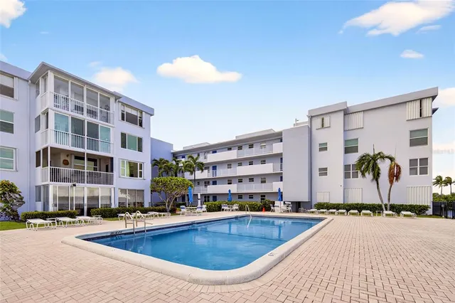 a swimming pool with outdoor seating and yard