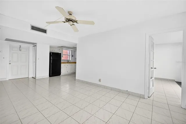 a view of an empty room with a ceiling fan