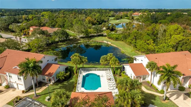 an aerial view of a house with a yard and lake view
