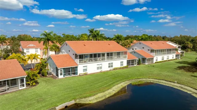 a aerial view of a house with swimming pool and a yard