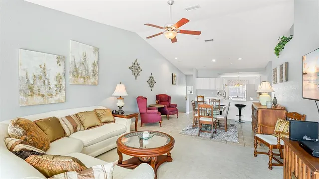 a living room with furniture kitchen and a window