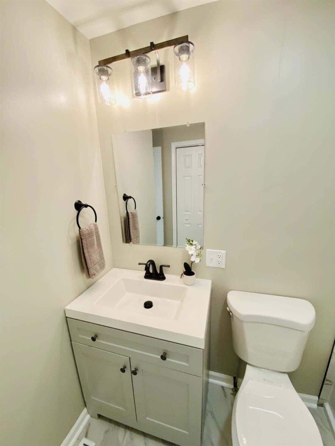745 Juniper Road Valparaiso, IN 46385 - Photo 18 of 28 a bathroom with a sink mirror and toilet