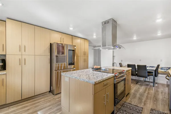 a open kitchen with stainless steel appliances granite countertop a sink and cabinets