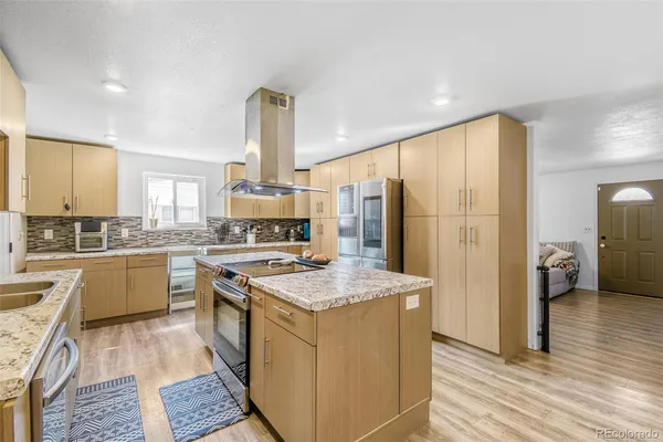 a kitchen with a sink stove and refrigerator