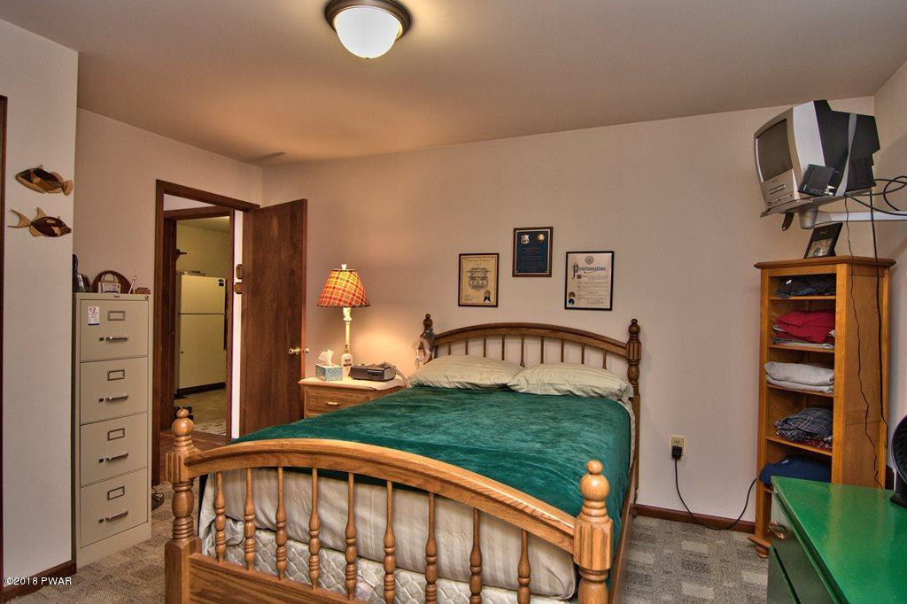 1 East Lake Road Moscow, PA 18444 - Photo 31 of 88 a view of a bedroom with furniture and staircase
