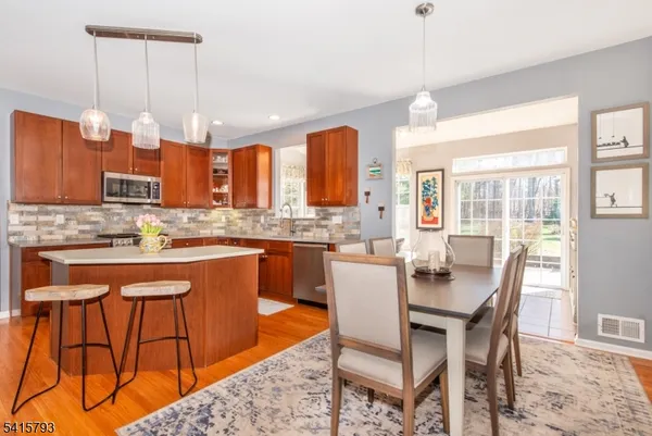 a large kitchen with a table and chairs in it