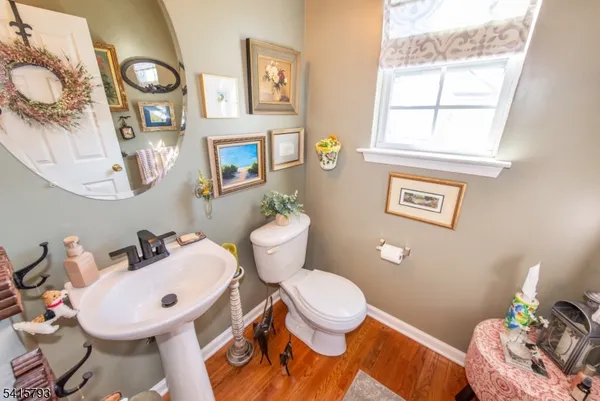 a bathroom with a toilet a sink and a mirror