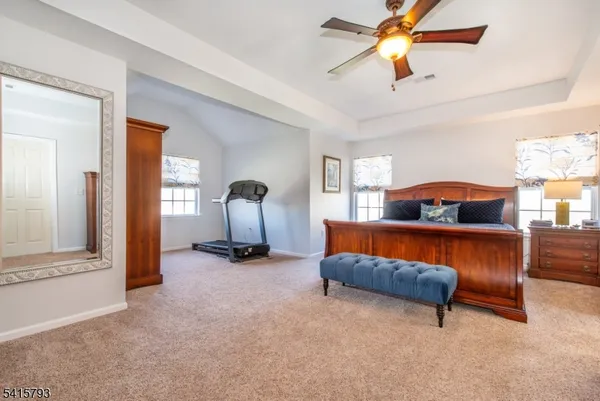 a living room with furniture a ceiling fan and a window
