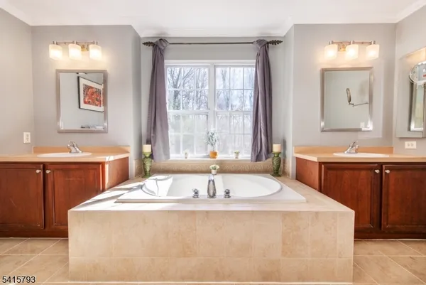 a bath tub sitting next to a bathroom sink