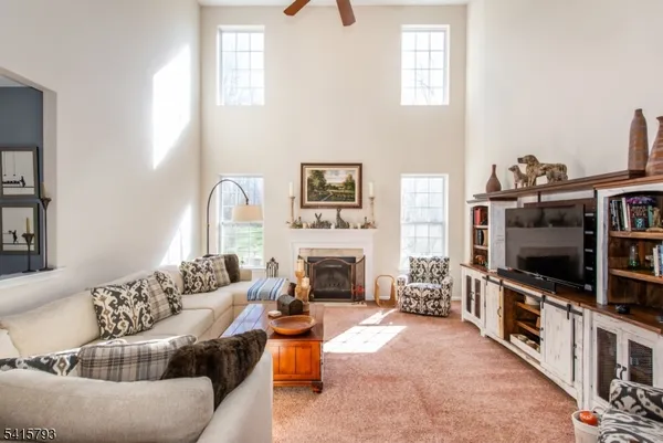 a living room with furniture flat screen tv and fireplace