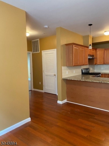 25 Cottage Street, Unit 4 Newark, NJ 07102 - Photo 4 of 13 a view of a kitchen with wooden floor and a sink