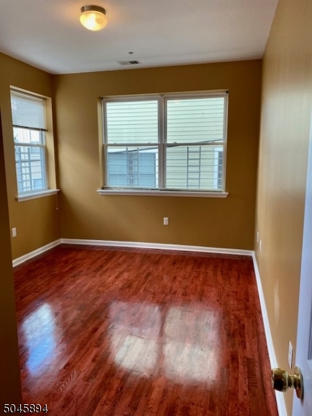 25 Cottage Street, Unit 4 Newark, NJ 07102 - Photo 6 of 13 a view of an empty room with wooden floor and a window