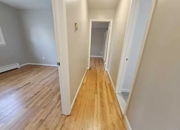 a view of hallway with wooden floor