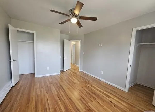 a view of empty room with wooden floor
