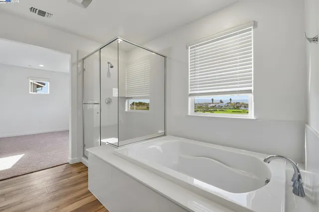 a bathroom with a bathtub and a shower