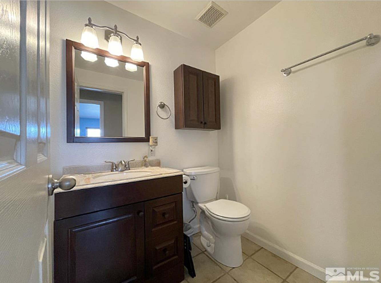 562 Yellow Jacket Road Dayton, NV 89403 - Photo 13 of 27 a bathroom with a toilet sink and mirror