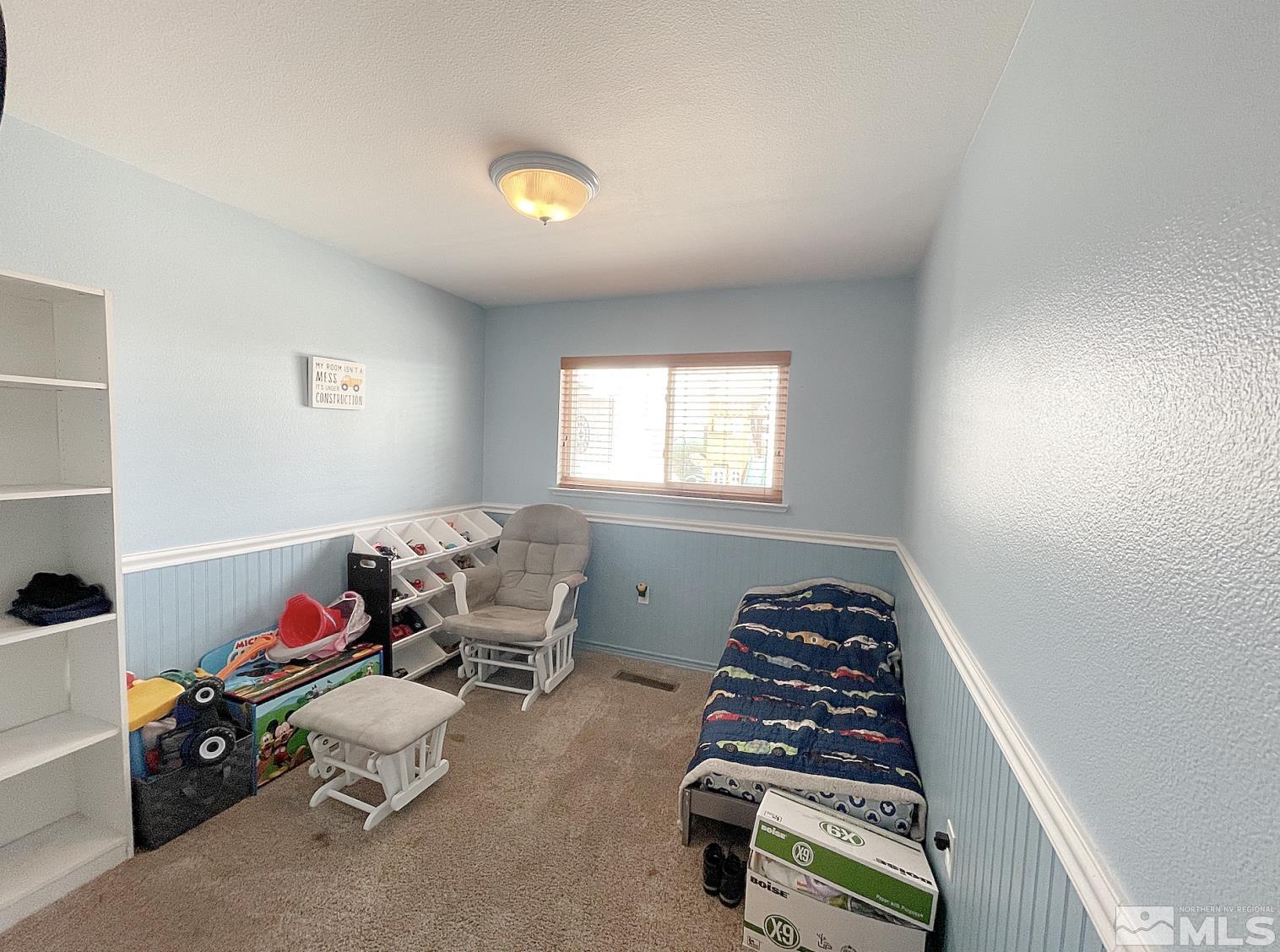 562 Yellow Jacket Road Dayton, NV 89403 - Photo 19 of 27 a room with furniture and a window