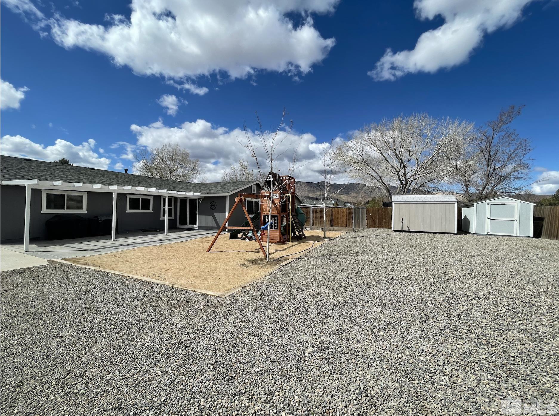 562 Yellow Jacket Road Dayton, NV 89403 - Photo 23 of 27 a view of a house with a backyard space and a yard