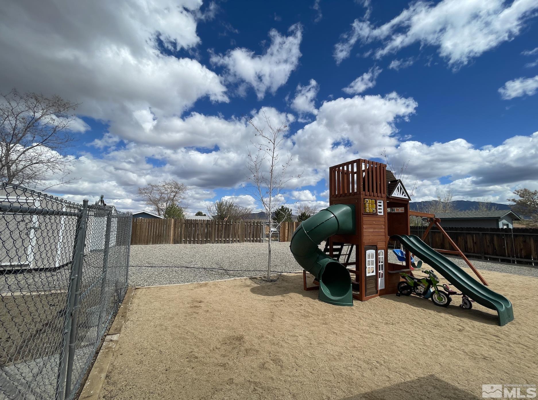 562 Yellow Jacket Road Dayton, NV 89403 - Photo 26 of 27 a view of a roof deck with chair and iron fence