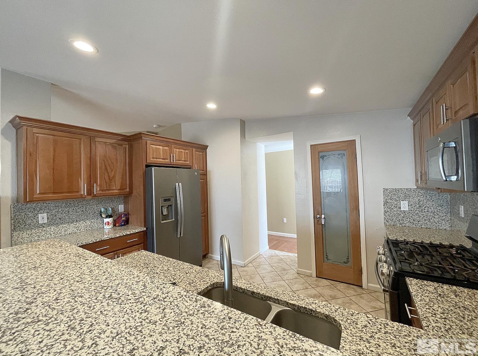 562 Yellow Jacket Road Dayton, NV 89403 - Photo 7 of 27 a bedroom with a bed a dresser and mirror