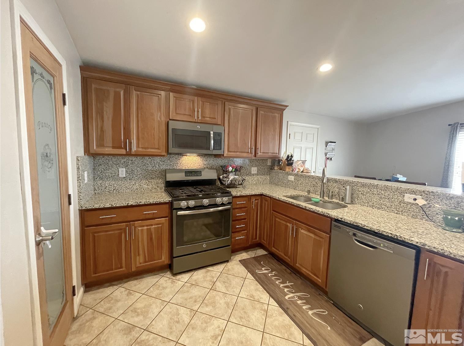 562 Yellow Jacket Road Dayton, NV 89403 - Photo 8 of 27 a kitchen with stainless steel appliances granite countertop a stove sink and cabinets