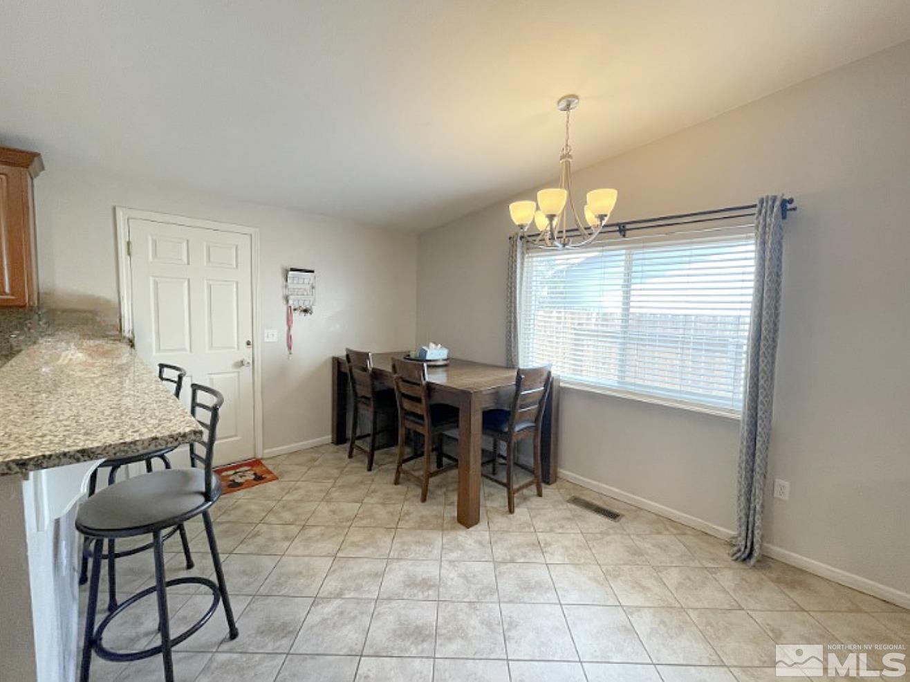 562 Yellow Jacket Road Dayton, NV 89403 - Photo 9 of 27 a view of a dining room with furniture and chandelier