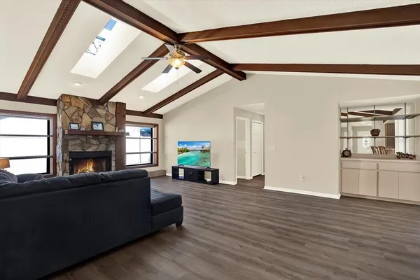 a living room with furniture and a wooden floor