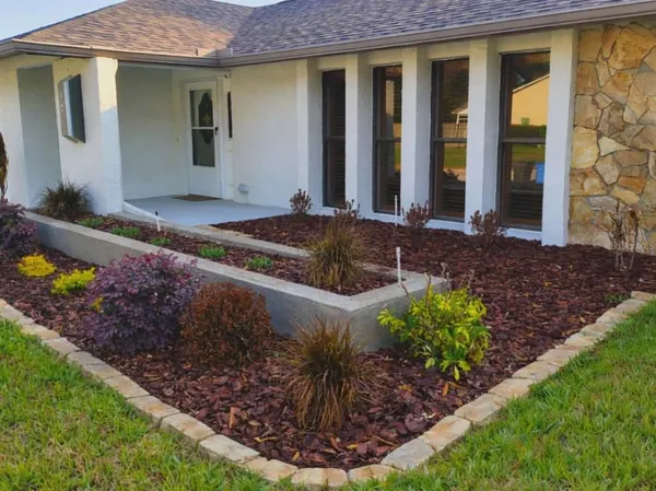 a front view of a house with garden
