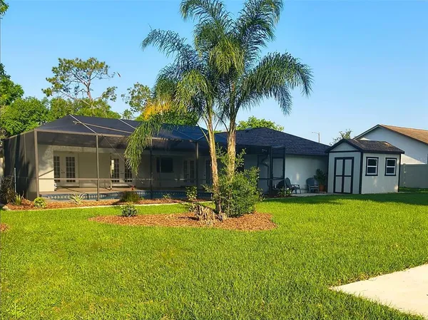 a view of a house with swimming pool and a yard